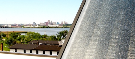 A view of downtown Baltimore framed by a solar thermal collector on the roof of Lucky's 